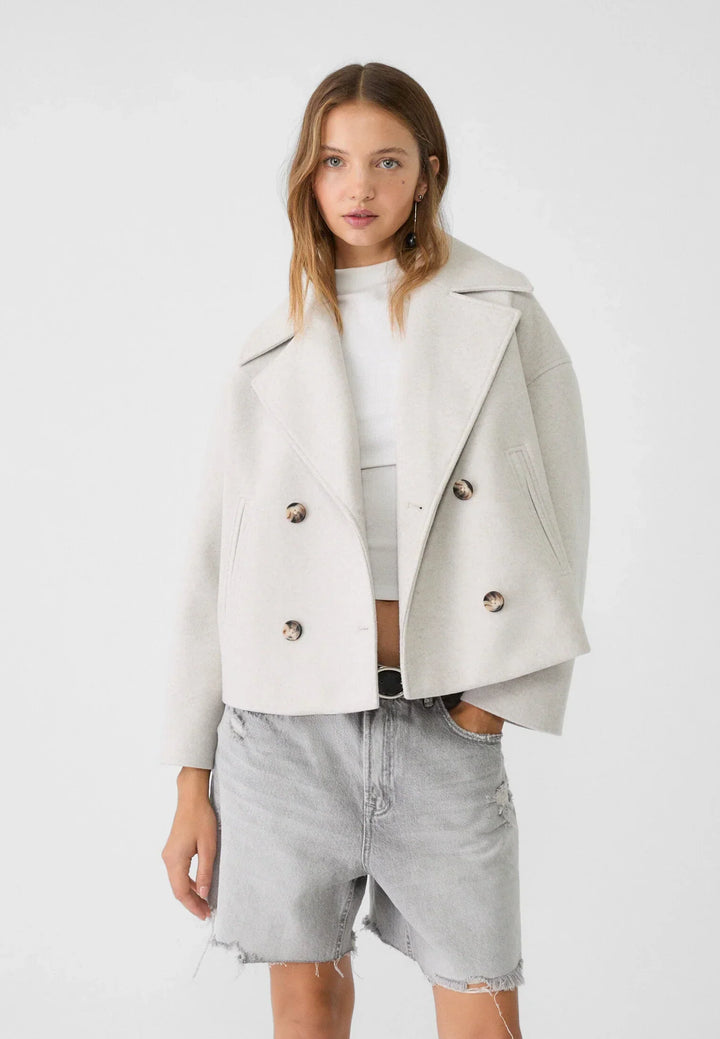 Short women's coat with double row of buttons made of vegan leather