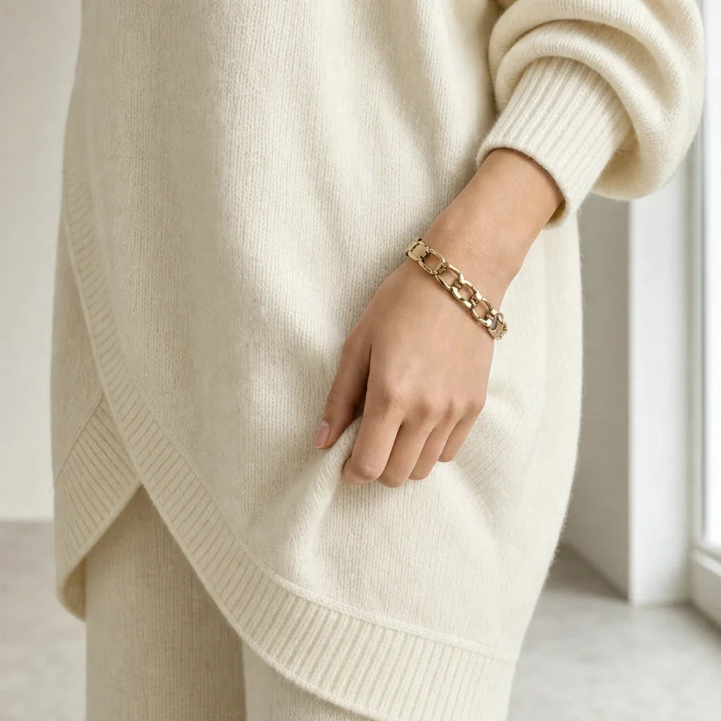 Knit two-piece set with gold buttons and an asymmetrical cut