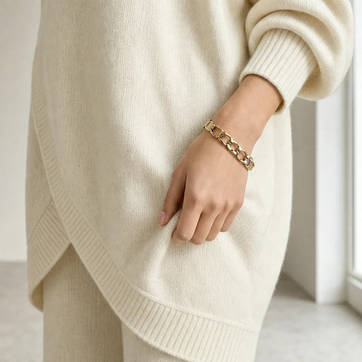 Knit two-piece set with gold buttons and an asymmetrical cut